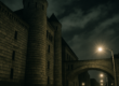 A nighttime view of the Old Allegheny County Jail’s towering gray stone walls and the iconic “Bridge of Sighs” arching over Ross Street. The fortress-like Romanesque structure looms under a cloudy sky, illuminated by streetlights that cast long shadows – an imposing reminder of Pittsburgh’s past where history and ghostly legends meet.
