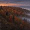 Illustration of an autumn ridge at dusk in the Laurel Highlands with a dark shape among the trees