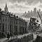 Illustration of a Lower Hill District row-house street with a wrecking crane at the end of the block and the downtown skyline behind.